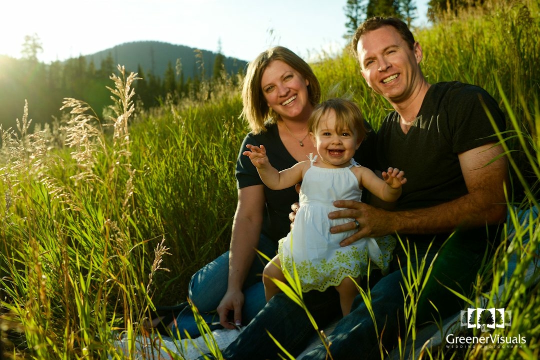young-family-smiles-in-golden-mountain-meadow-Hyalite-Reservoir-Family-Portrait