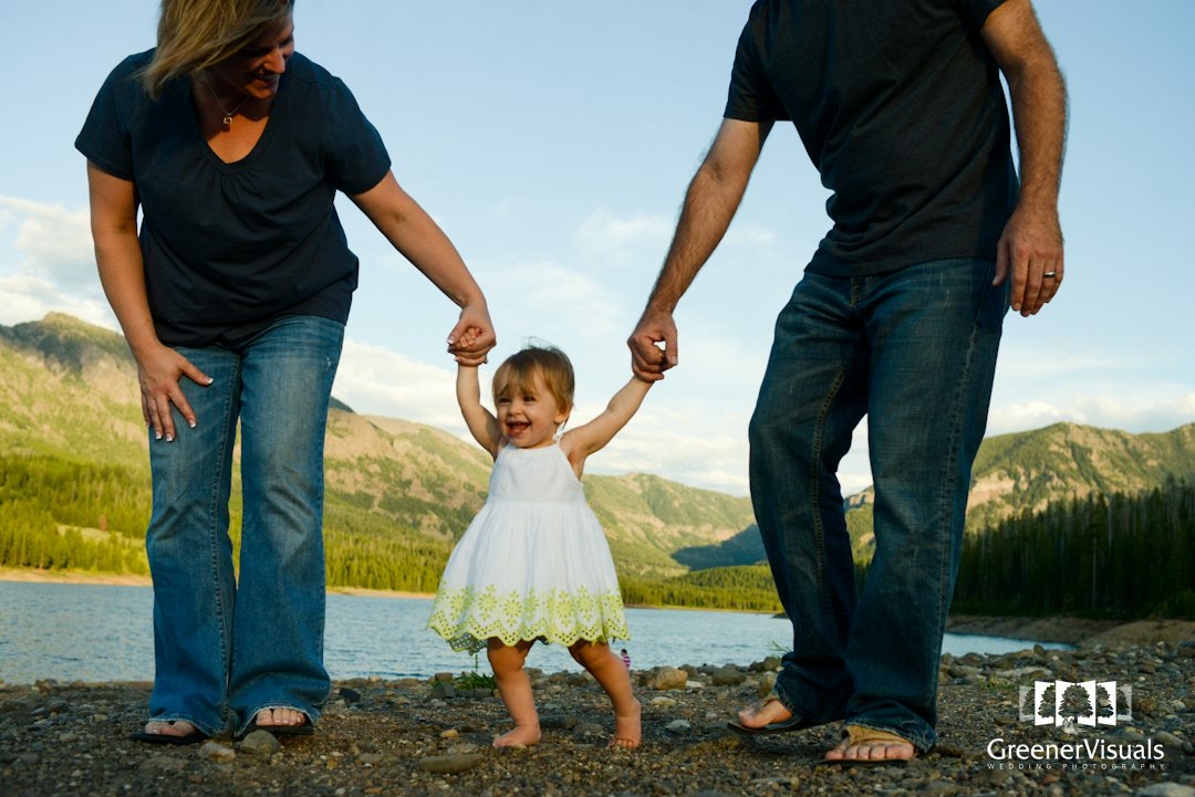 young-family-walks-holding-daughters-hands-during-Hyalite-Reservoir-Family-Portrait