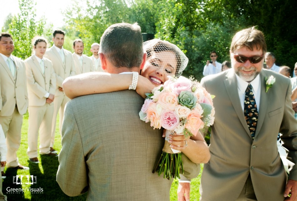 bride-hugs-with-pink-orange-flowers-Best-of-2014-Wedding