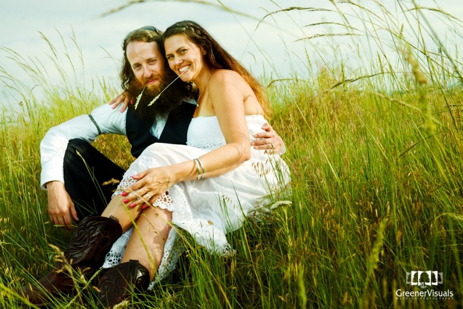 bride-and-groom-sit-in-tall-grass-Best-of-2014-Wedding