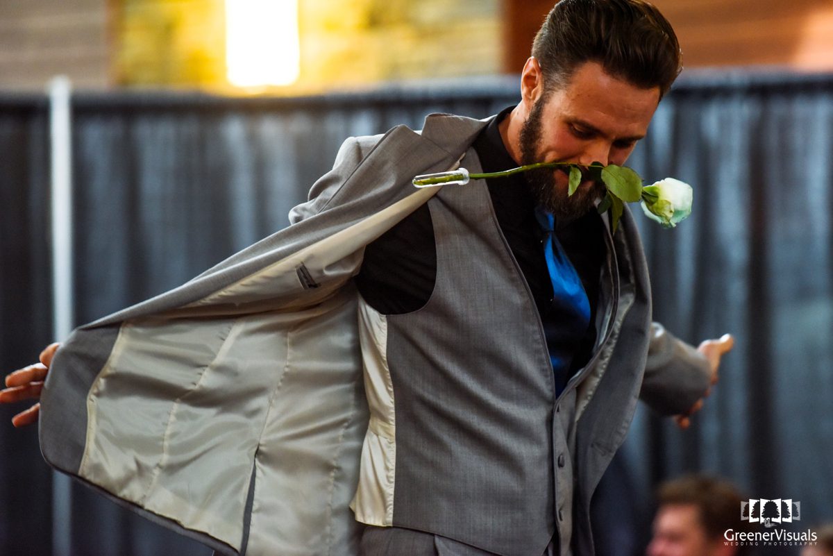 man-with-white-rose-in-teeth-at-Bridal-Event-in-Bozeman