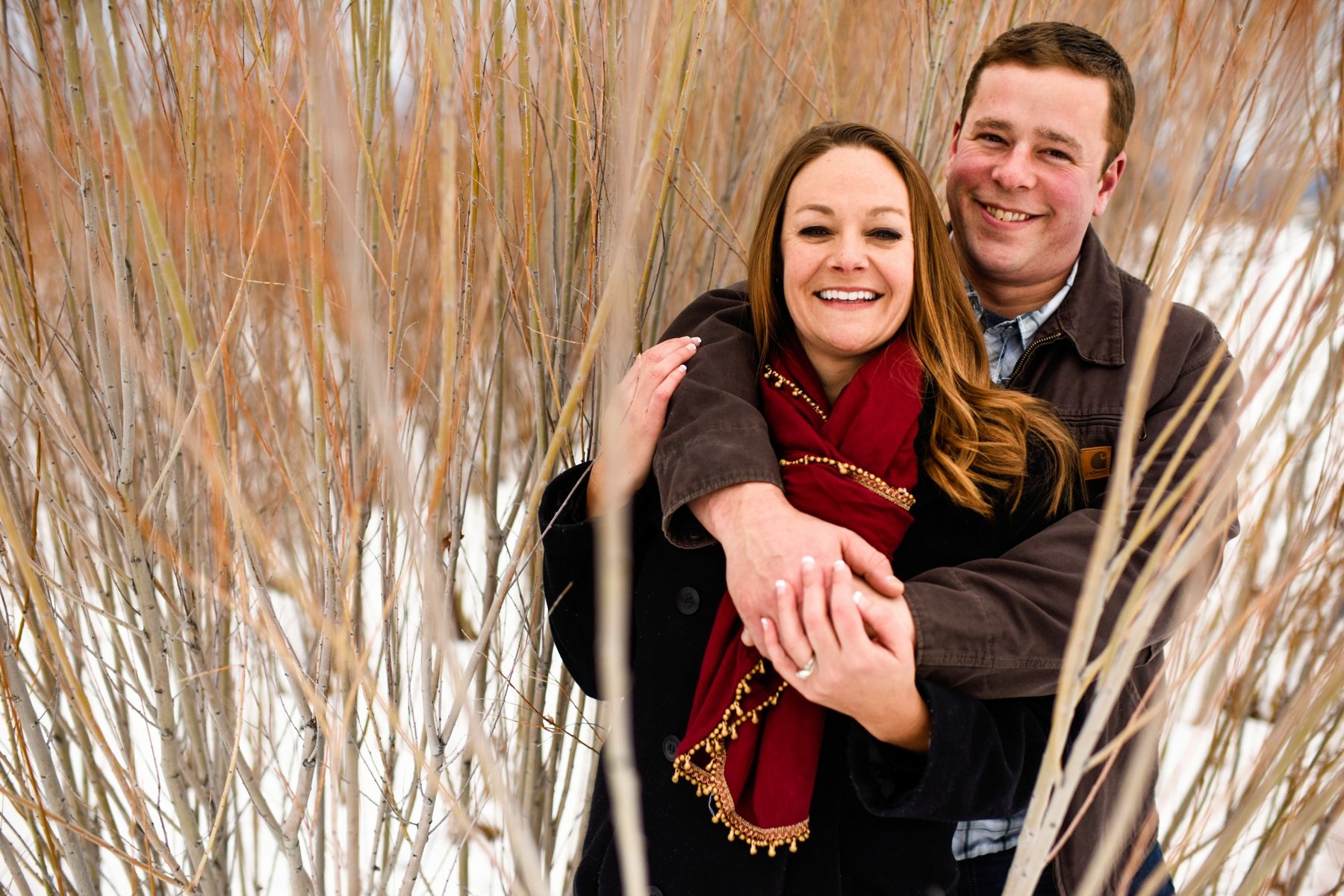 couple-embrace-in-willows-during-engagement-photo-session-Bozeman