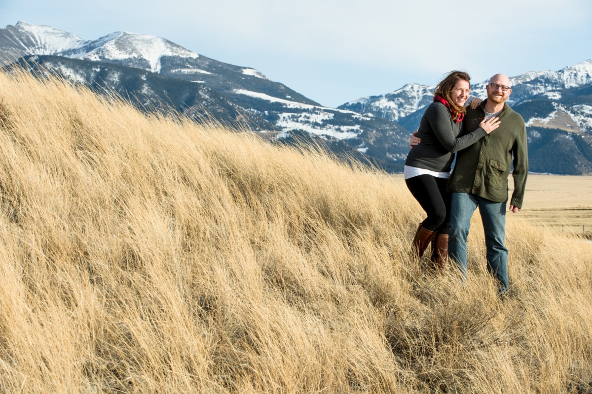 couple-laughing-in-the-wind-during-Ennis-Montana-Engagement-Photos