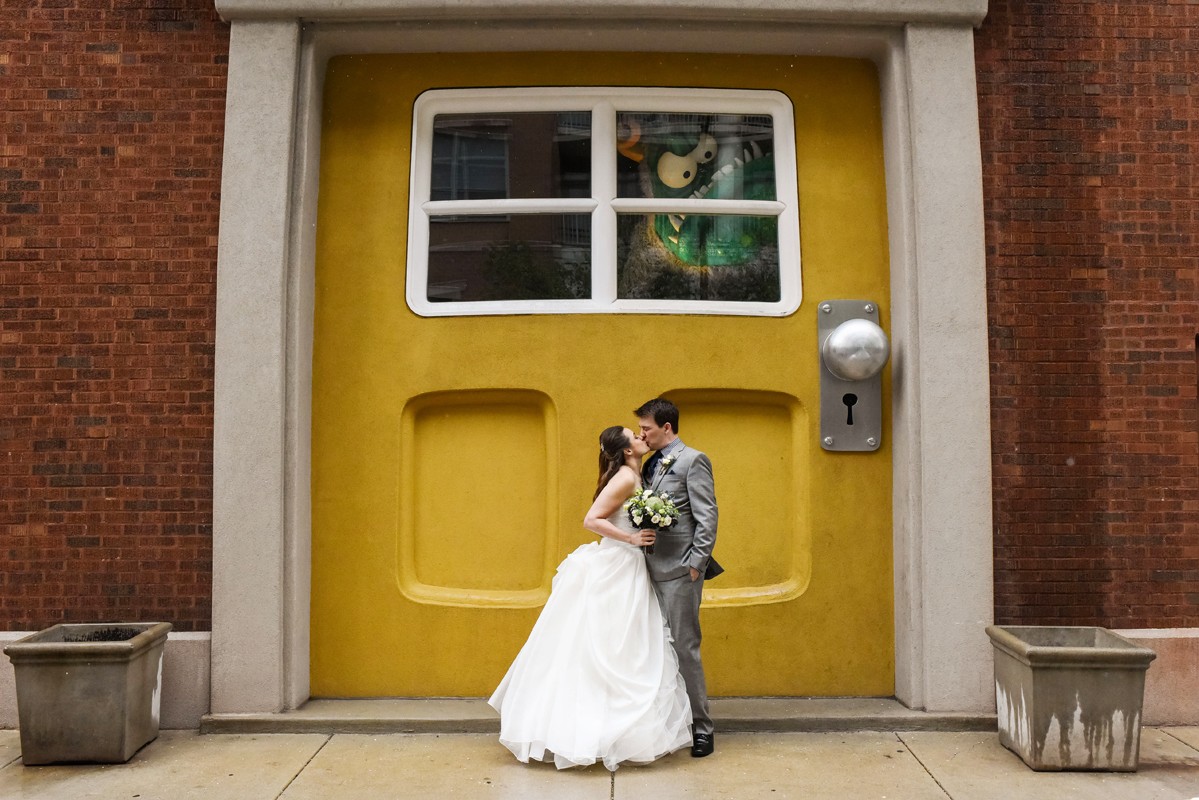 big-yellow-door-wedding-couple-kiss