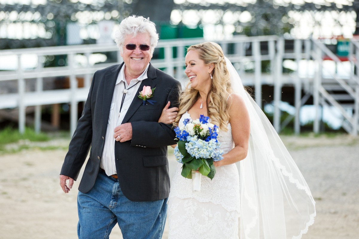 bride-walks-aisle-with-father-at-mountain-top-ceremony-during-Whitefish-Mountain-Resort-Wedding