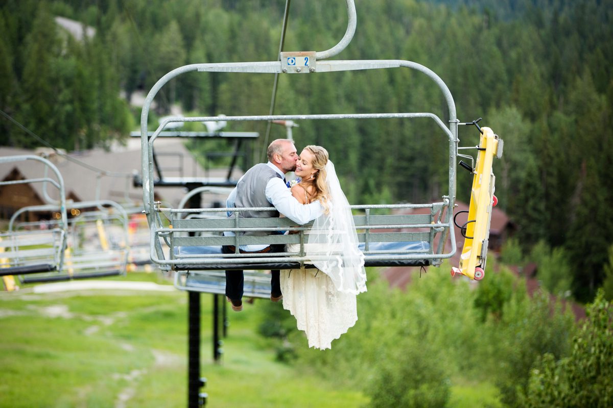bride-and-groom-ride-chairlift-at-Whitefish-Mountain-Resort-Wedding