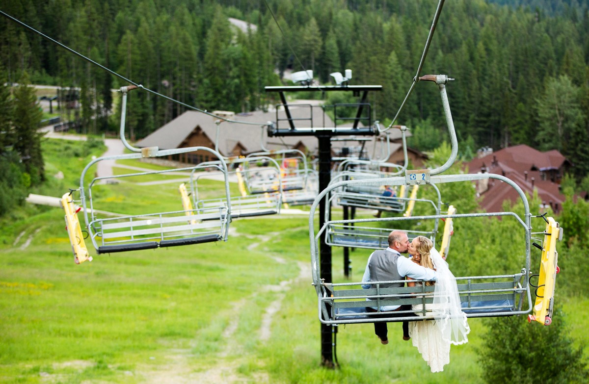 bride-and-groom-kiss-riding-chairlift-at-Whitefish-Mountain-Resort-Wedding