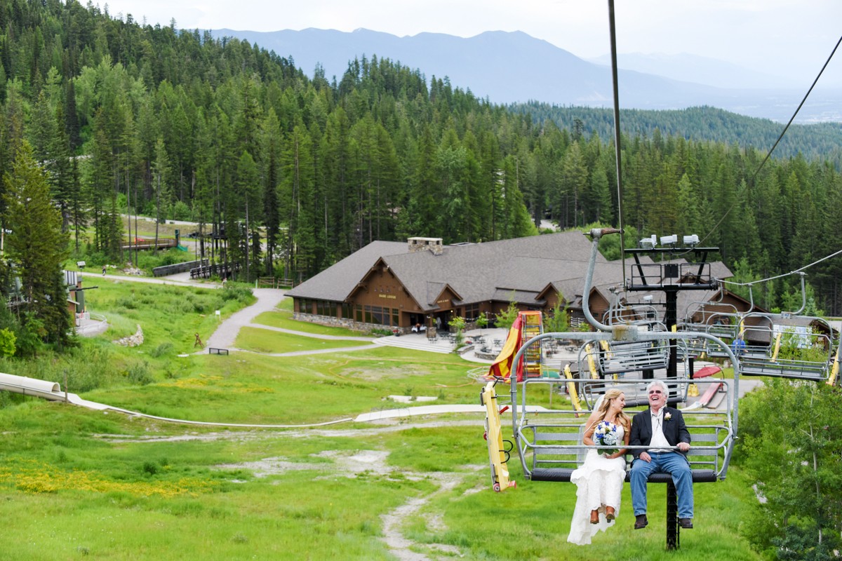 bride-with-father-rides-chairlift-to-mountain-top-ceremony-during-Whitefish-Mountain-Resort-Wedding