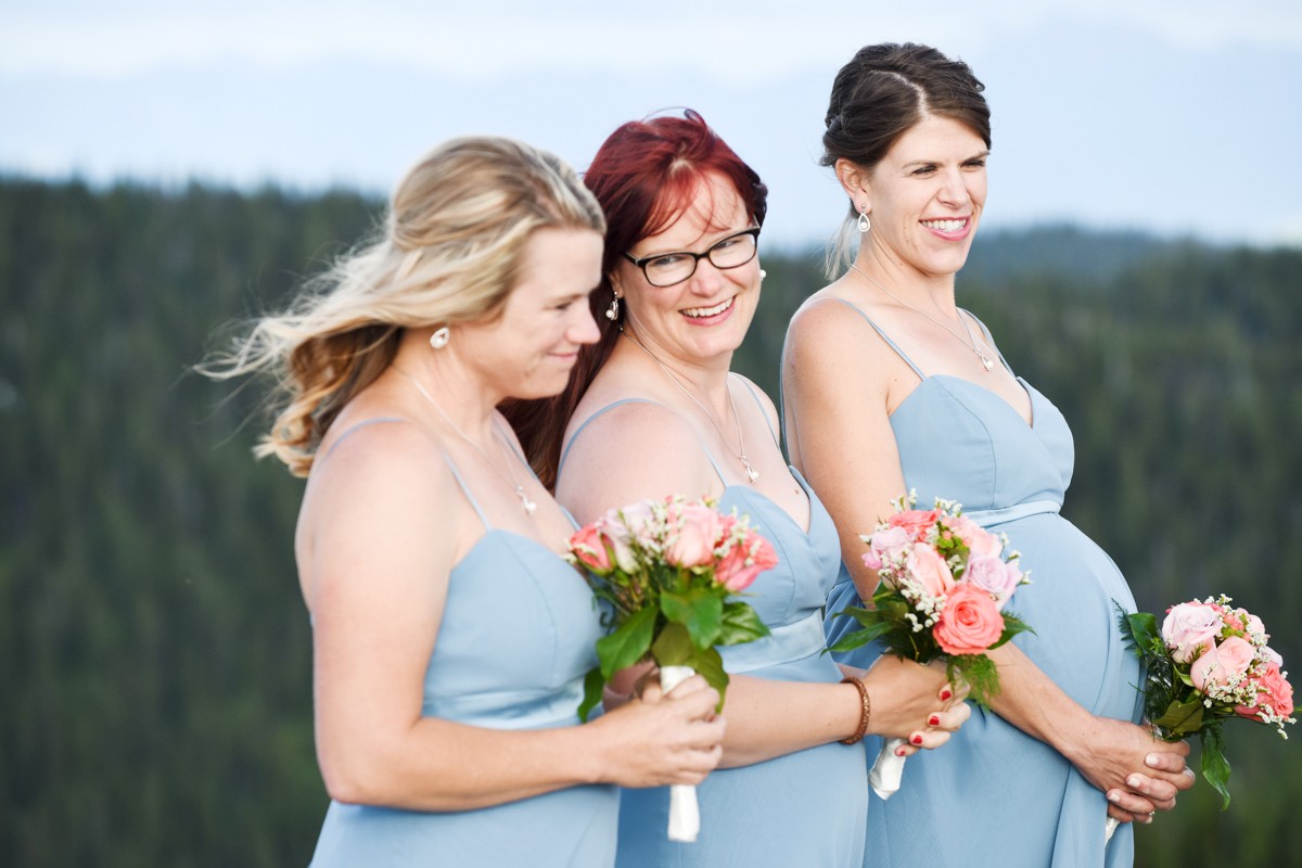 bridesmaids-smile-during-mountain-top-ceremony-at-Whitefish-Mountain-Resort-Wedding