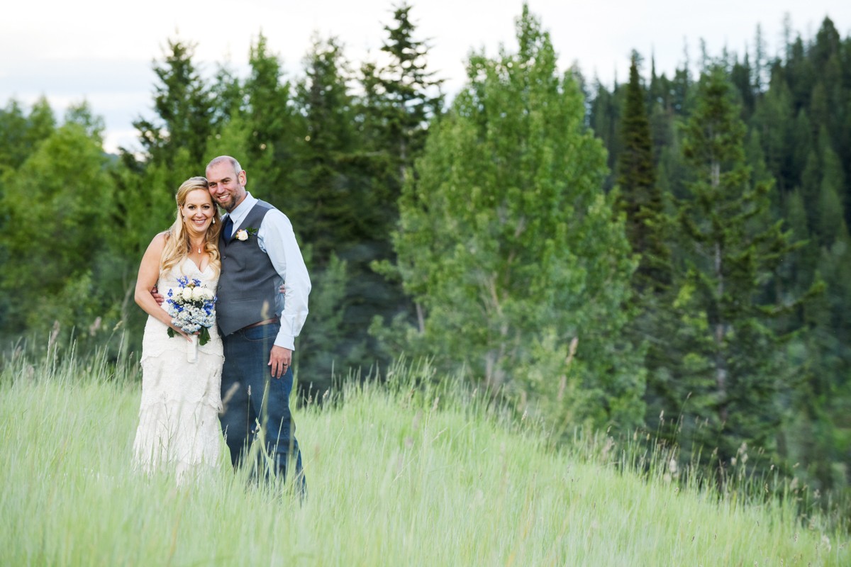 newlyweds-in-mountain-forest-meadow-during-their-Whitefish-Mountain-Resort-Wedding
