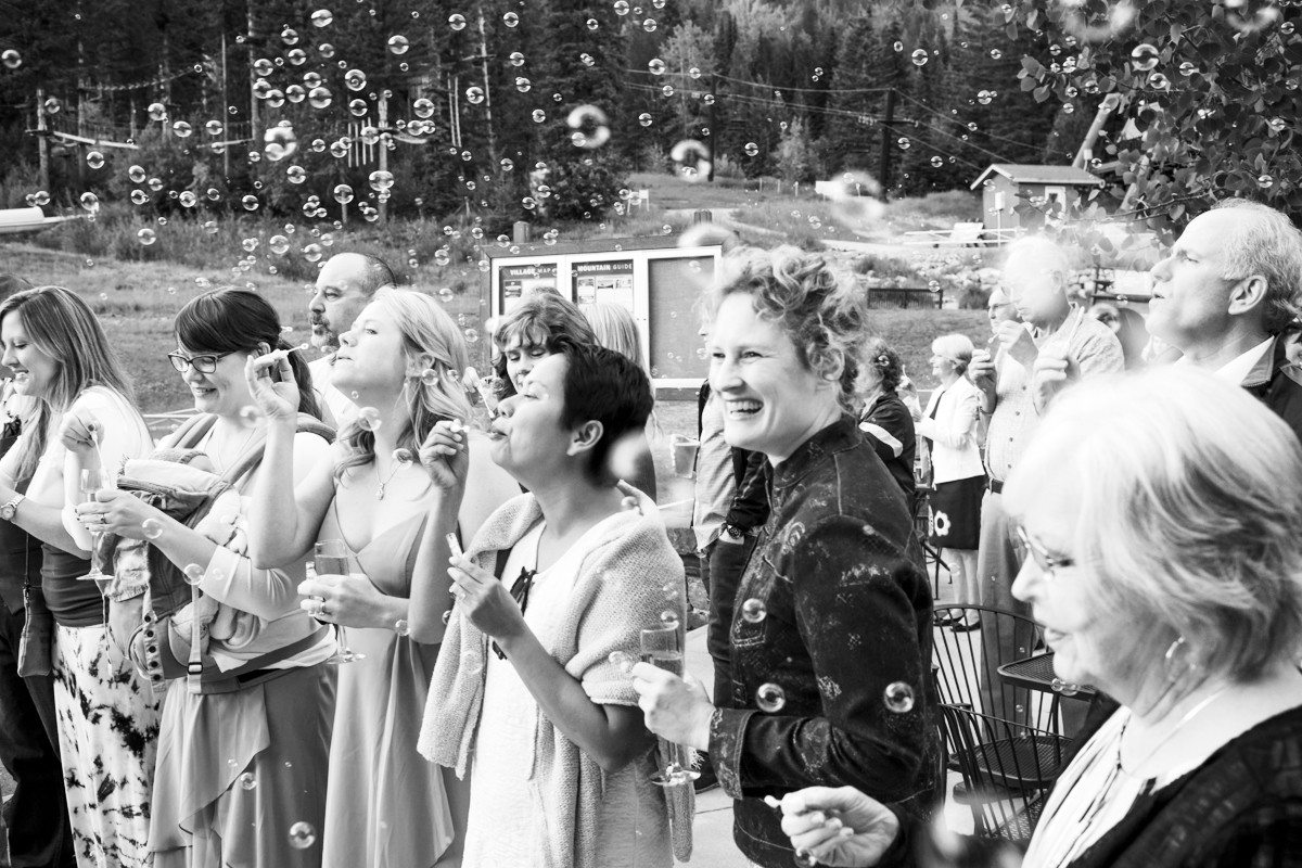 smiling-guests-during-bubble-grand-entrance-at-Whitefish-Mountain-Resort-Wedding-reception