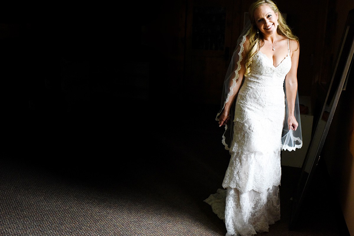 bride-smiles-in-window-light-Whitefish-Mountain-Resort-Wedding