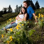 expecting-couple-cuddle-in-yellow-flowers-during-their-Bozeman-Maternity-Family-Portraits-session