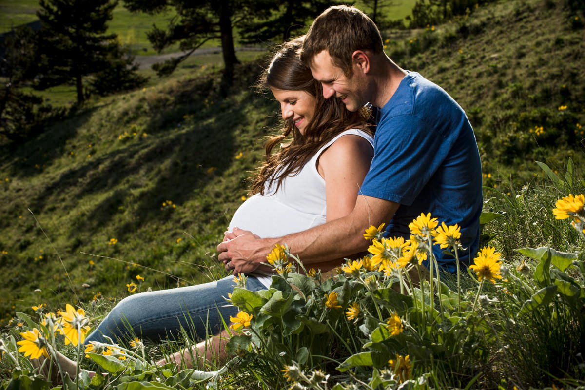expecting-couple-talk-to-belly-during-their-Bozeman-Maternity-Family-Portraits-session