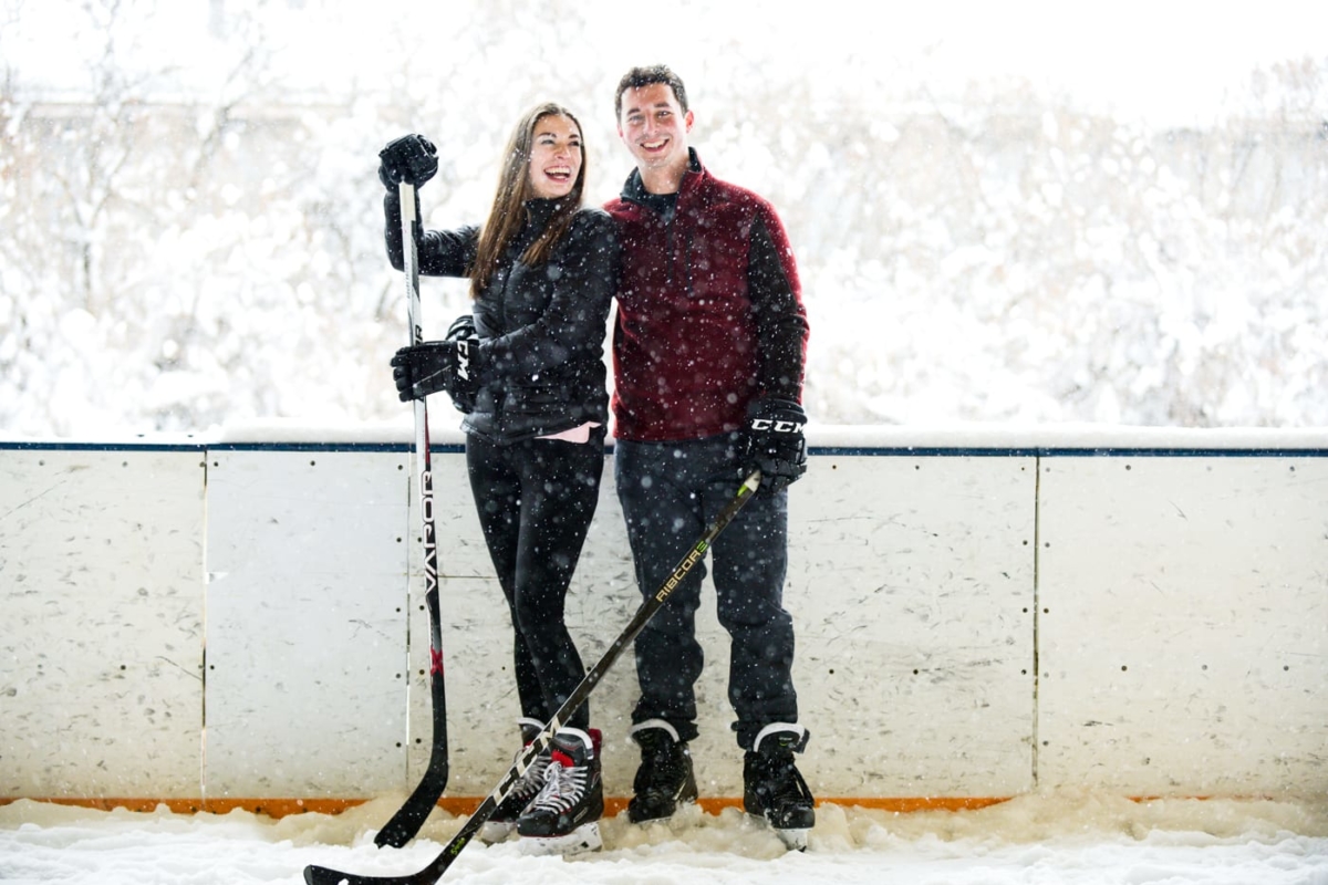 hockey-couple-smile-on-ice-during-Bogert-Park-Snowstorm-Portraits