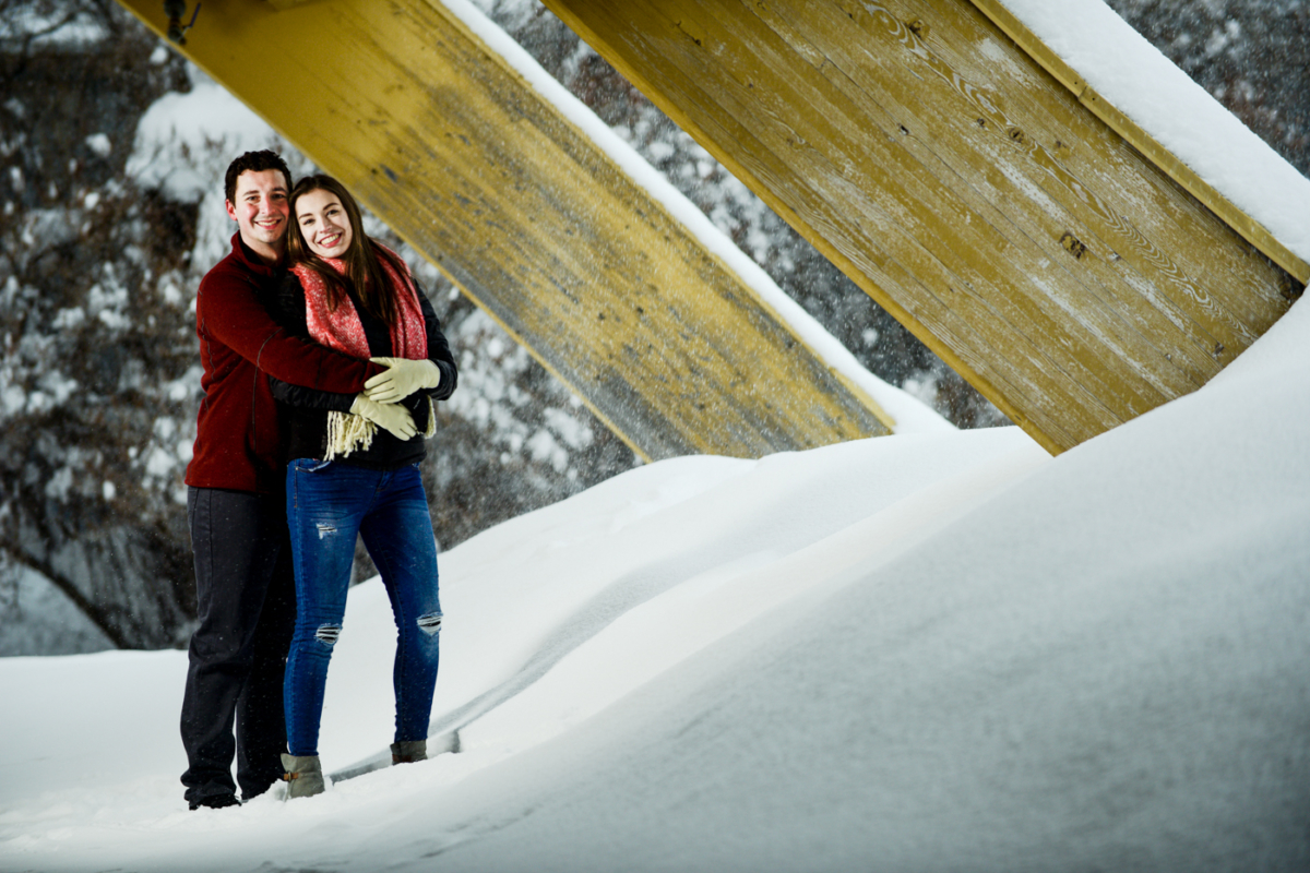 couple-embrace-under-yellow-braces-during-Bogert-Park-Snowstorm-Portraits