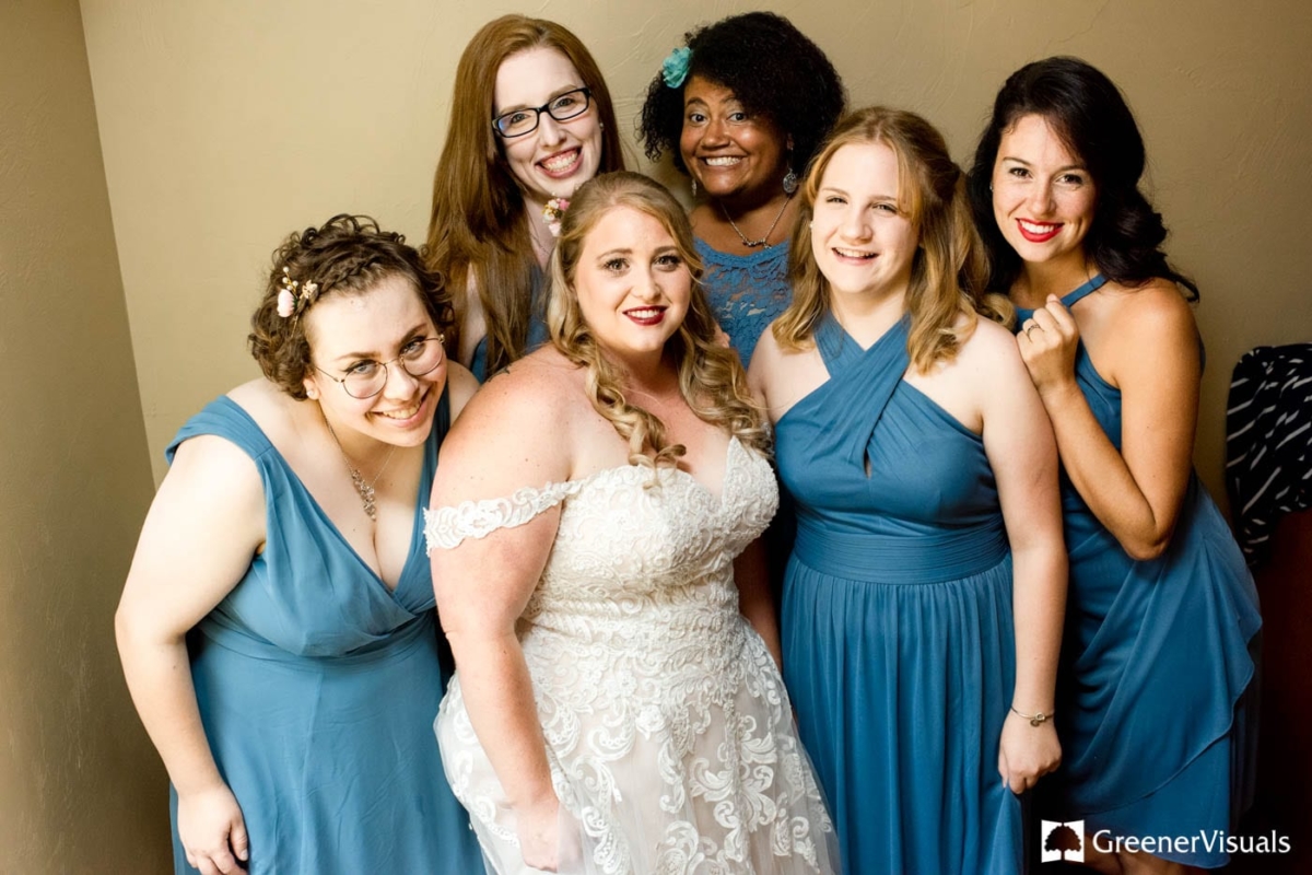 bride-smiles-with-bridesmaids-at-Holy-Rosary-Church-Wedding-Bozeman-Montana