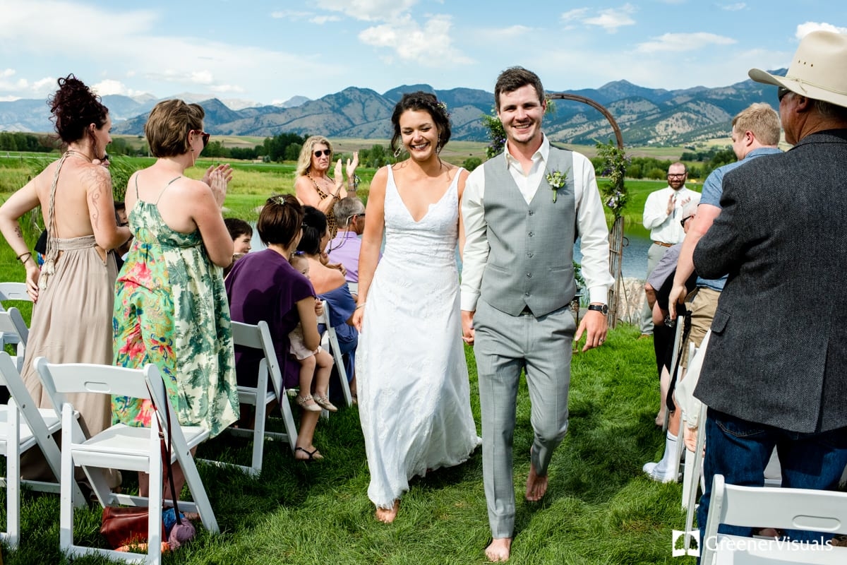 bride-and-groom-walk-down-aisle-during-Countryside-Bozeman-Montana-Wedding-ceremony