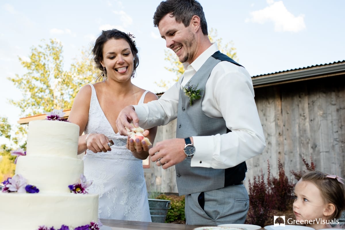 bride-and-groom-cake-cutting-at-Countryside-Bozeman-Montana-Wedding