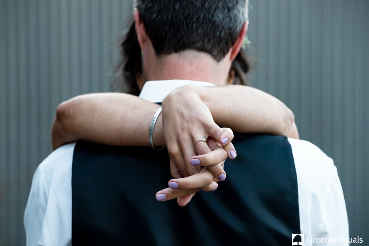 bride-holds-groom-tightly-during-Countryside-Bozeman-Montana-Wedding-first-dance