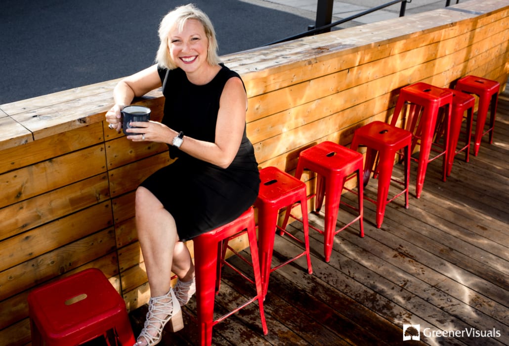realtor-Carla-Thorning-sitting-on-red-chairs-during-her-Bozeman-Business-Portraits