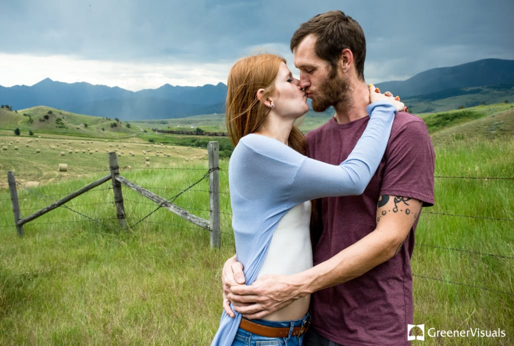 engaged-couple-kiss-with-mountain-rainstorm-in-background