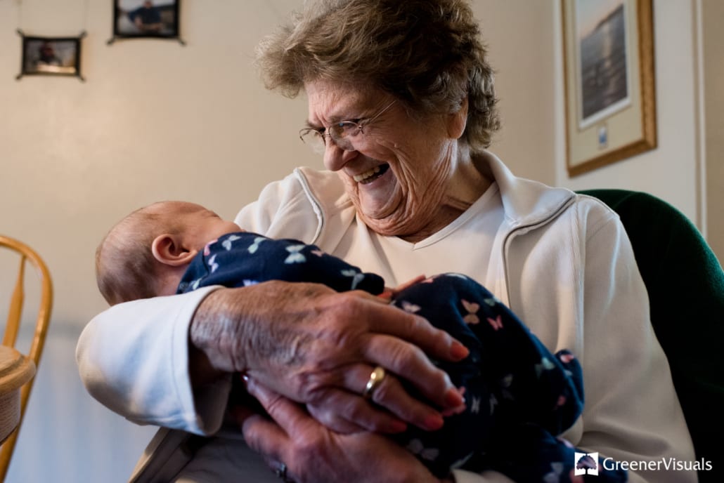 Jean-E-Greener-smiles-holding-her-granddaughter-for-first-time