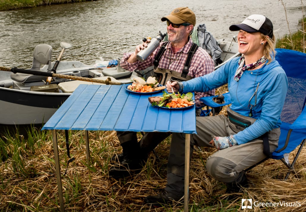 fishing-guides-eat-at-riverside-table