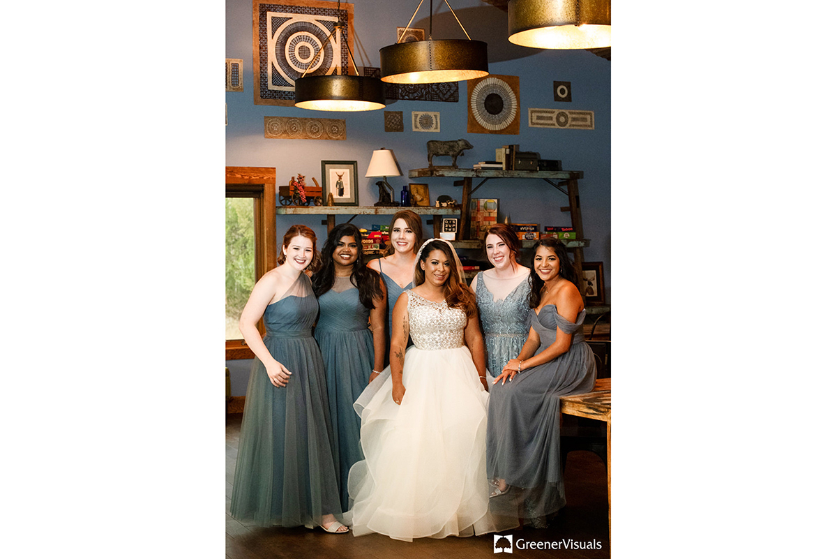 bride-with-bridesmaids-in-blue-dresses-barroom-portrait