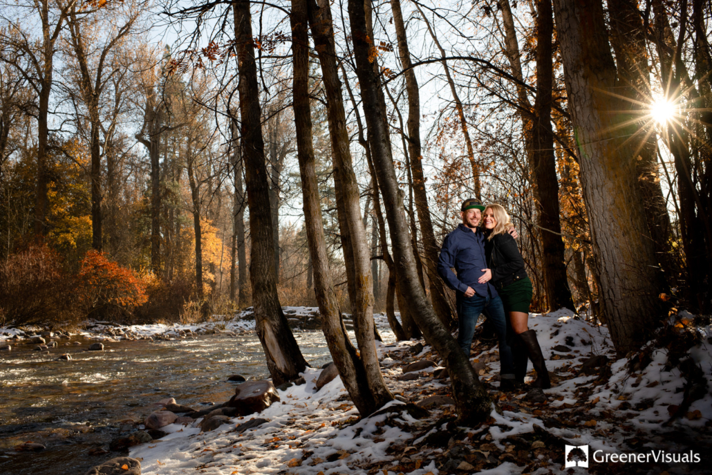 engaged-couple-embrace-along-Rattlesnake-Creek-Greenough-Park