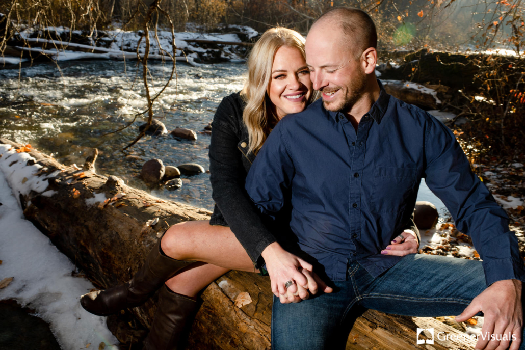 engaged-couple-cuddle-along-rattlesnake-creek