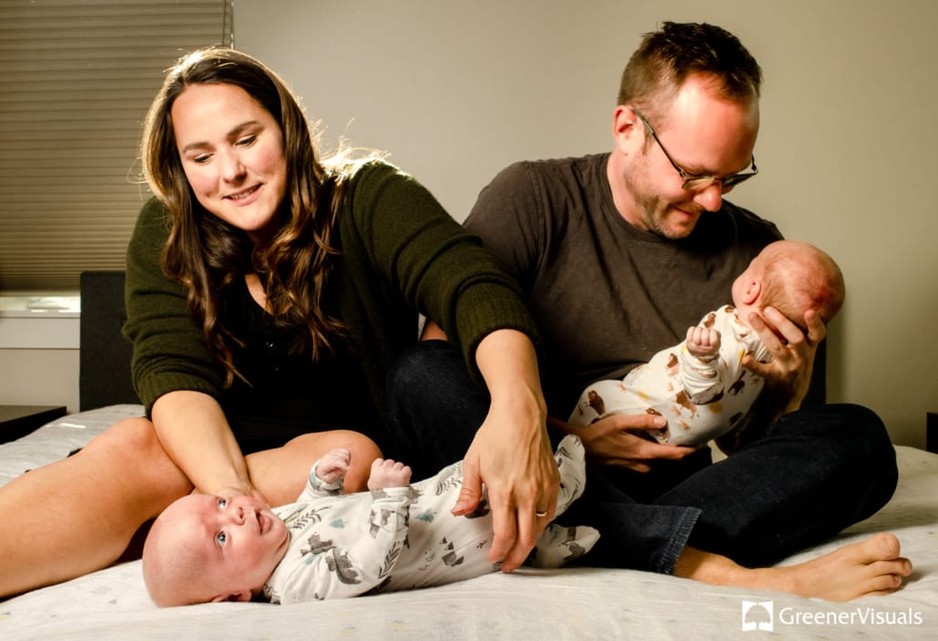 parents-holding-newborn-twin-boys-white-background