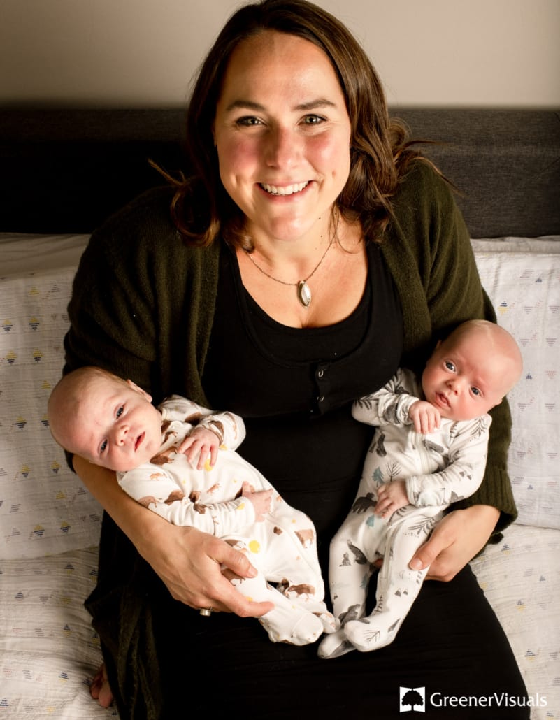 new-mother-holding-newborn-twin-boys-open-eyes