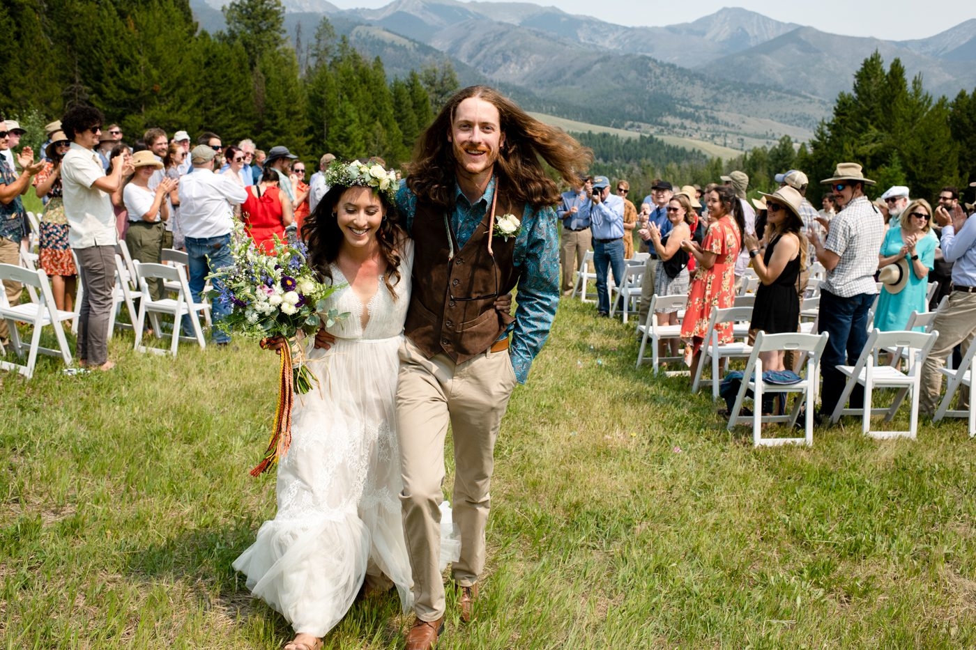smiling-newlyweds-walk-aisle-at-wedding