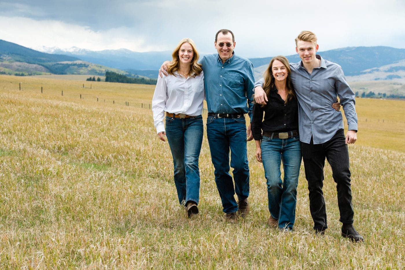 Family-walking-together-in-cloudy-mountain-field