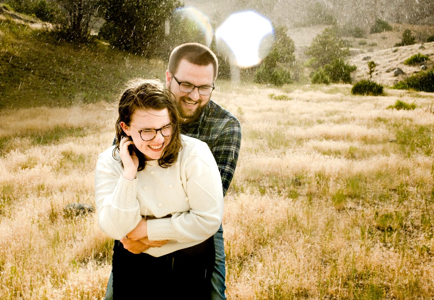 couple-laugh-in-surprise-rain-storm-portrait