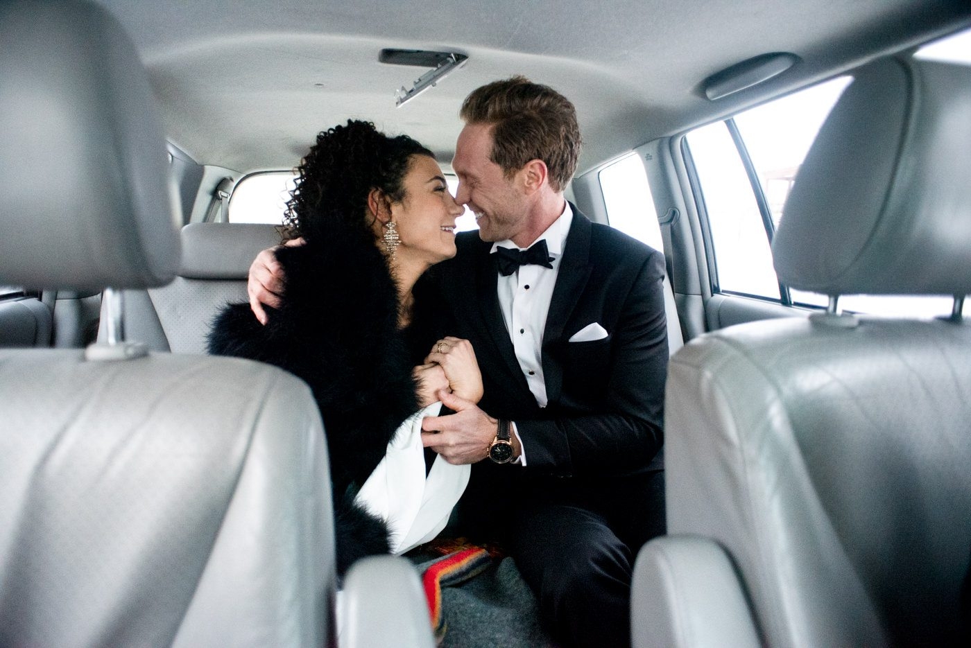 newlyweds-car-ride-embrace-in-downtown-Bozeman