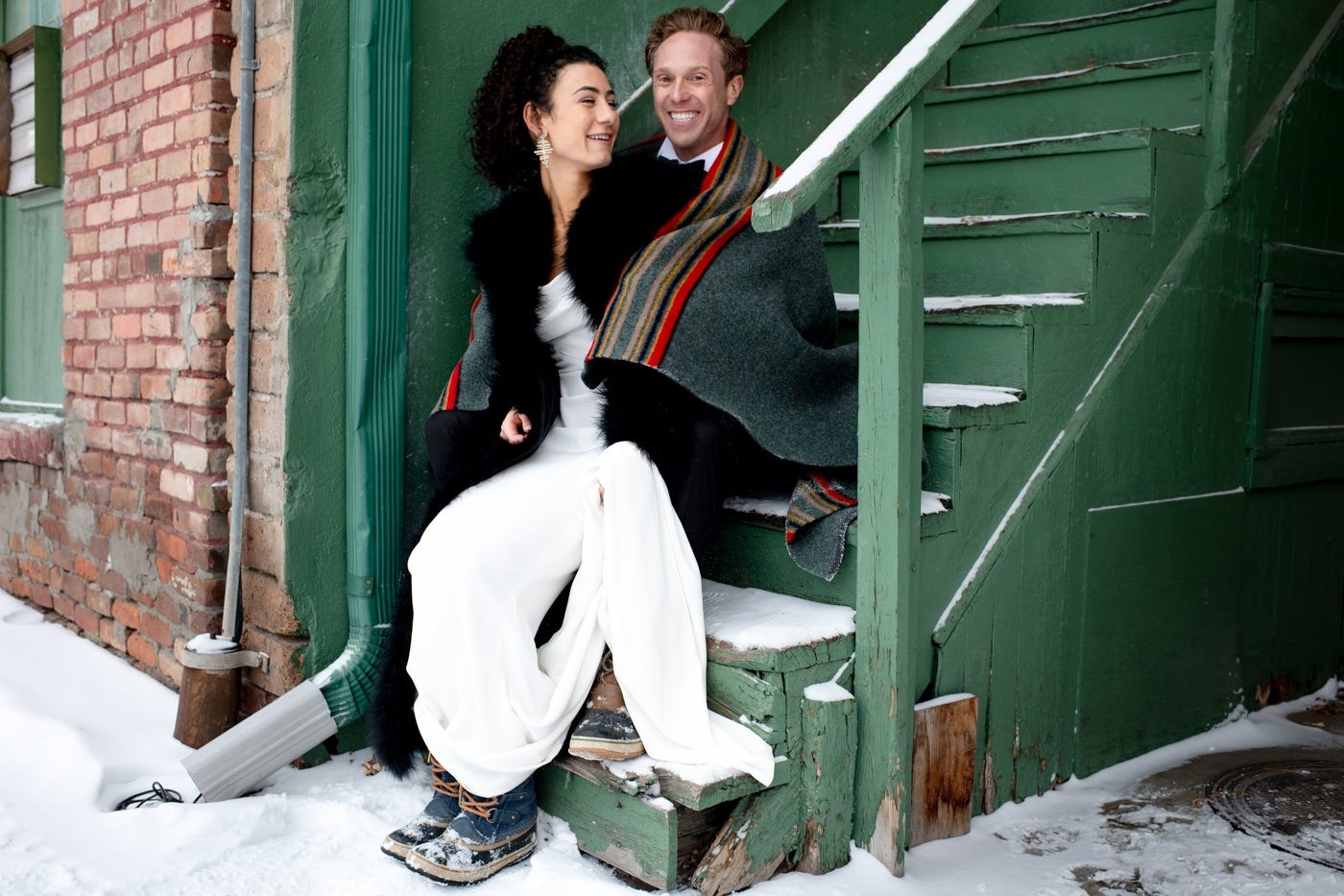 Wedding-Couple-laughing-portrait-on-green-stairs-Downtown-Bozeman