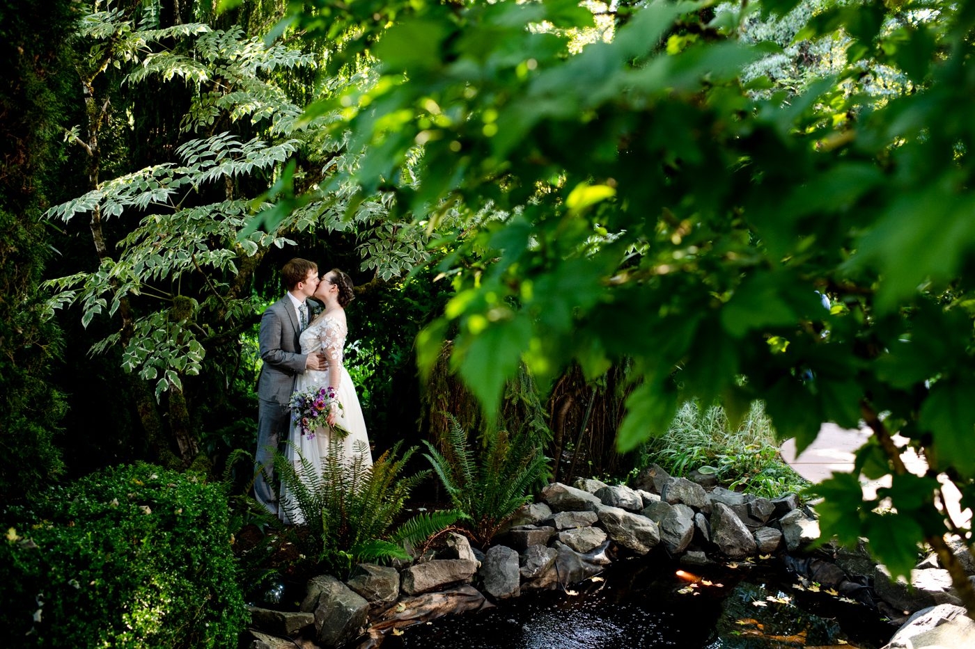 Newlyweds-surrounded-by-green-foliage