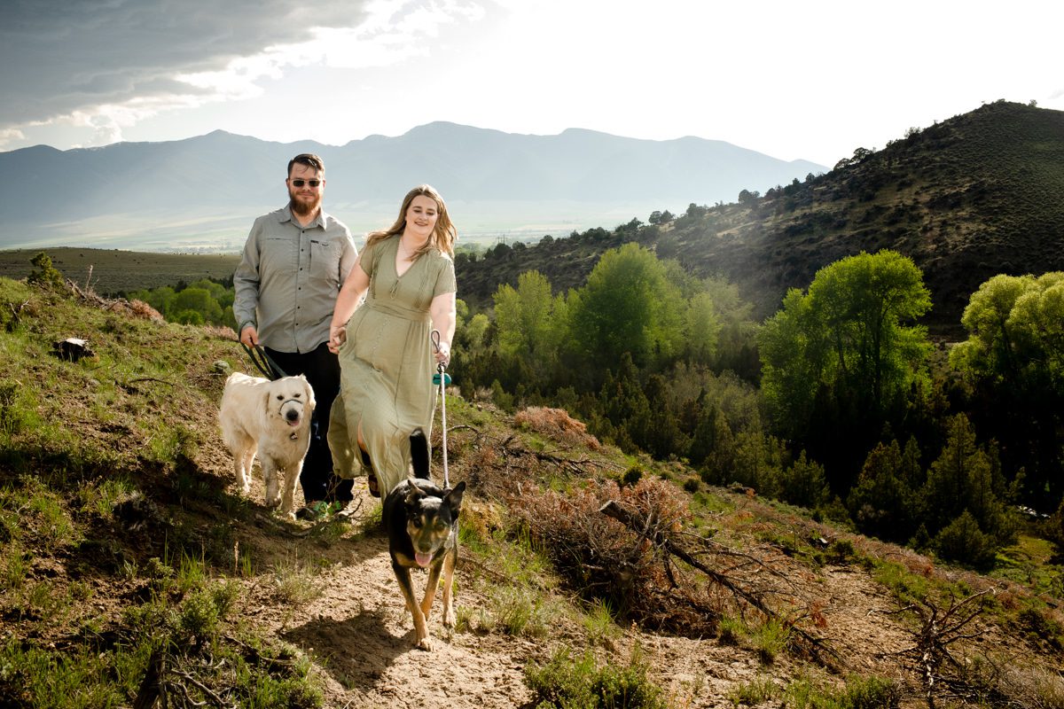 Engaged-couple-walking-dogs-in-Montana-Ruby-Valley-