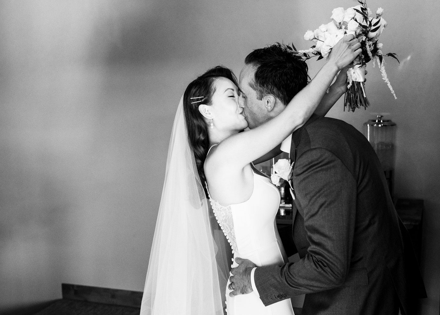 bride-kisses-groom-after-Skyview-at-Fall-River-Village-Resort-Estes-Park-Colorado-wedding-ceremony