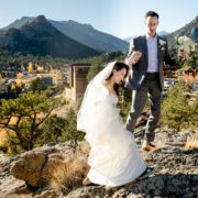 wedding-couple-climb-for-mountain-view-at-Skyview-at-Fall-River-Village-Resort-Estes-Park-Colorado