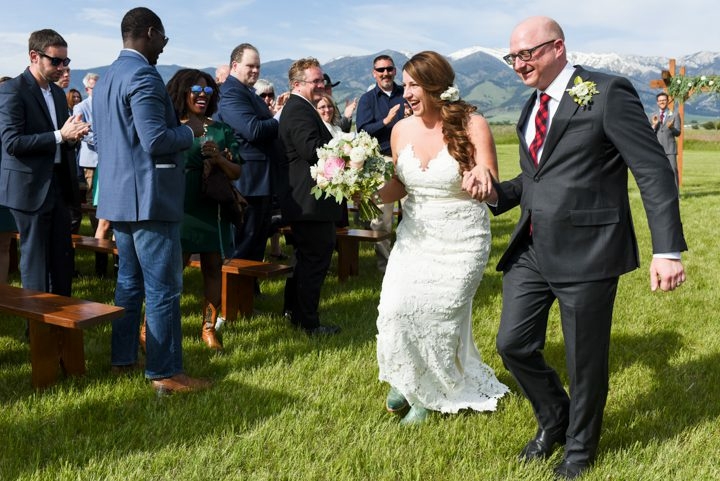 Newly-weds-walk-down-aisle-at-Big-Yellow-Barn-wedding