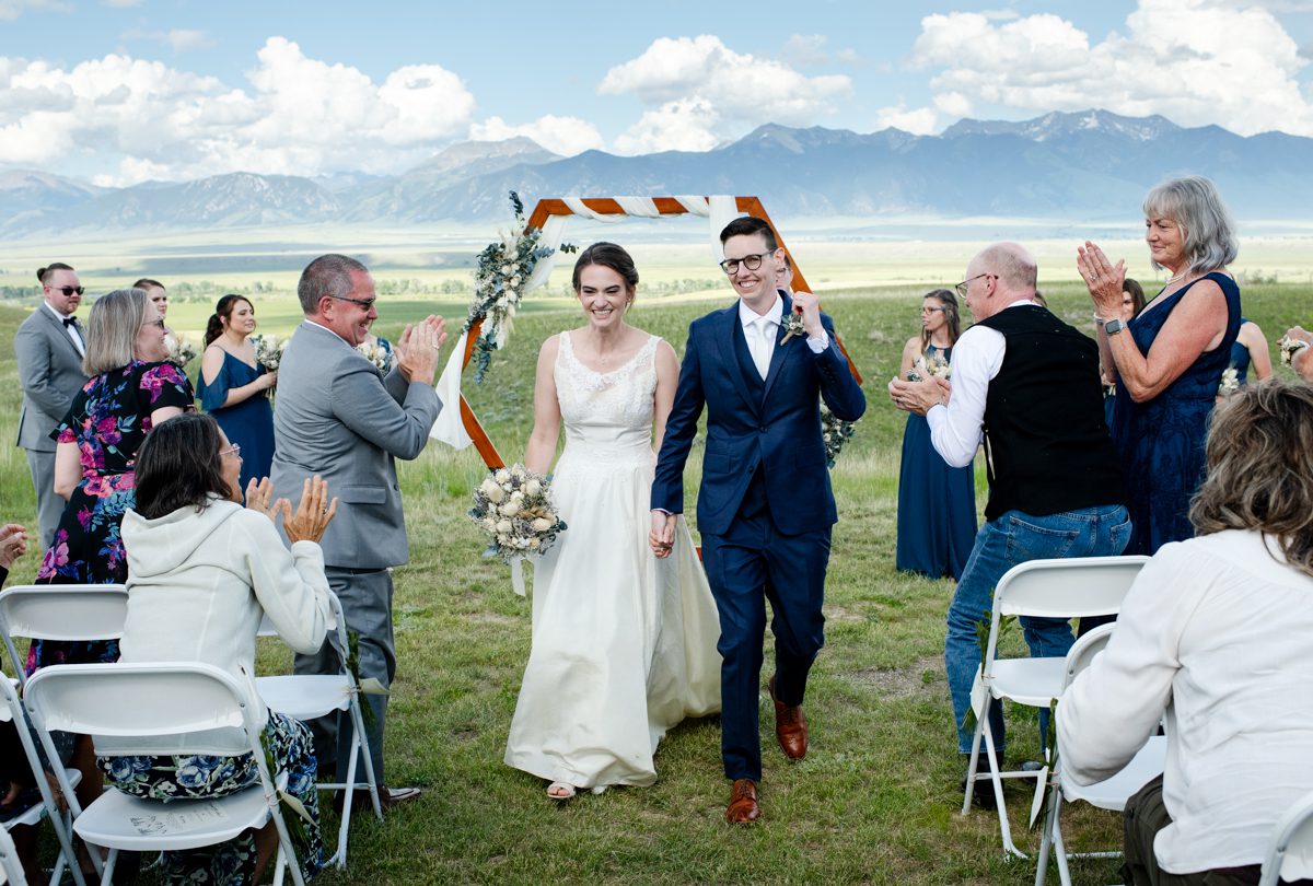 newlyweds-walk-down-aisle-during-their-ennis-montana-wedding