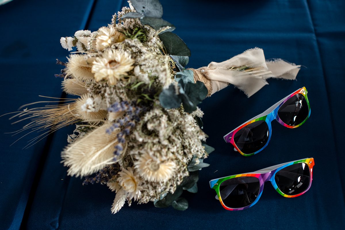 flower-bouquet-rainbow-sunglasses-on-blue-table