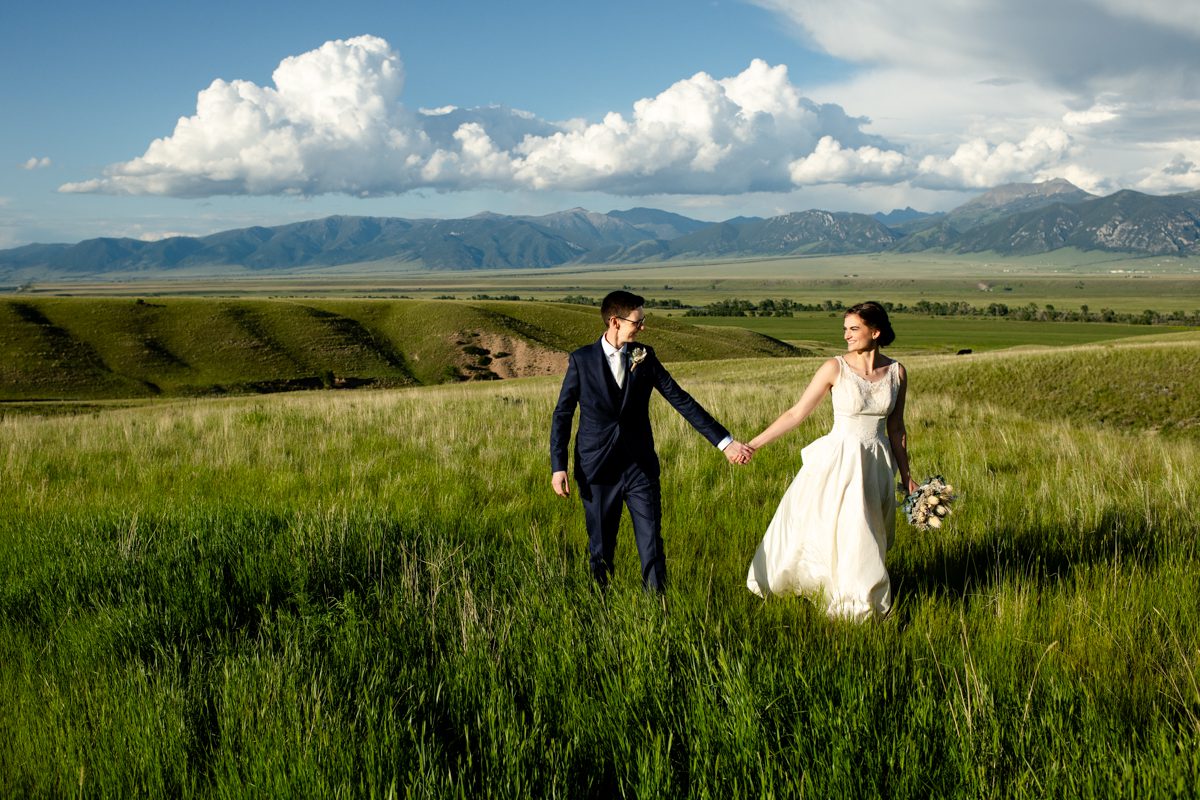 LGBTQ-newlyweds-walk-in-green-grass-Montana-Madison-valley