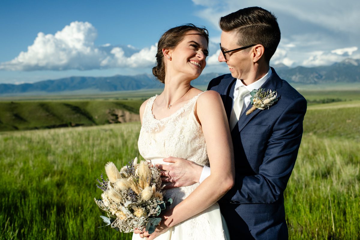 LGBTQ-couple-in-green-grass-Montana-valley