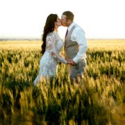 Newlyweds-kiss-in-wheat-field