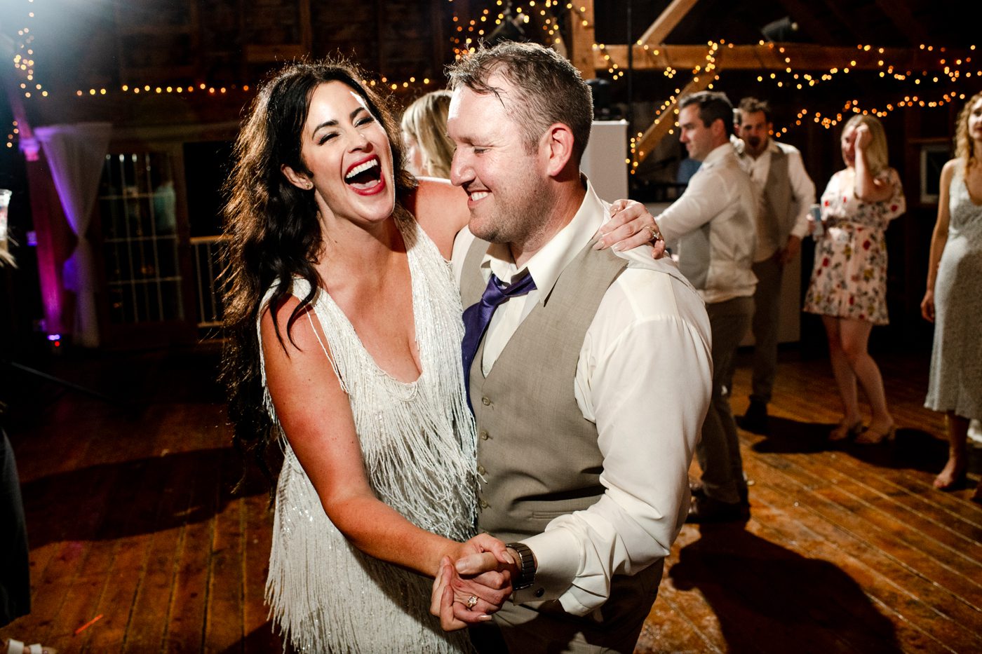 Newlyweds-laugh-and-dance-at-Roys-Barn