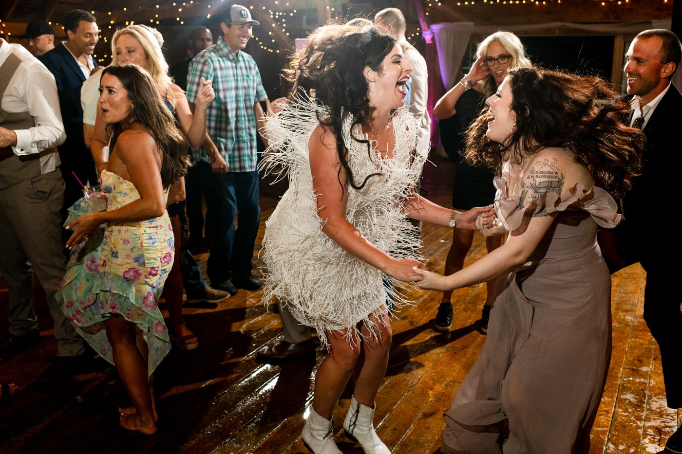 bride-jumps-on-dancefloor-with-bridesmaid